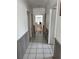 Hallway with tiled flooring and neutral walls, leading to other rooms at 2026 Aaron Pl, Clearwater, FL 33760