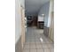 Open-concept floor plan with tile flooring, seamlessly connecting living, dining, and kitchen areas at 2026 Aaron Pl, Clearwater, FL 33760