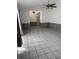 Spacious living room featuring tile floors, a ceiling fan, and ample natural light at 2026 Aaron Pl, Clearwater, FL 33760