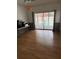 Cozy living space features laminate floors, a sliding door view of the pool, and space for relaxation at 2026 Aaron Pl, Clearwater, FL 33760