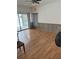 Open floor plan living space with sliding glass doors leading to pool area and laminate flooring at 2026 Aaron Pl, Clearwater, FL 33760
