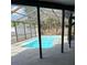 Sparkling pool is surrounded by a screened enclosure offering shade from the sun at 2026 Aaron Pl, Clearwater, FL 33760
