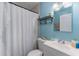 Cozy bathroom featuring a shower with blue-striped curtain and blue wall at 2035 29Th N Ave, St Petersburg, FL 33713
