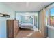 Bright bedroom with closet, a mounted television, slider to the outside, and ceiling fan at 2035 29Th N Ave, St Petersburg, FL 33713