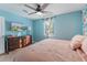 Bedroom showing a dresser, ceiling fan, and a large window with patterned curtains at 2035 29Th N Ave, St Petersburg, FL 33713