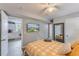 Comfortable bedroom showcases a bright, patterned bedspread and convenient access to the kitchen at 2035 29Th N Ave, St Petersburg, FL 33713