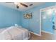 Charming bedroom with light blue walls, ceiling fan, and mounted TV at 2035 29Th N Ave, St Petersburg, FL 33713