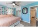 Charming bedroom featuring floral curtains, a ceiling fan, closet, and access to bathroom at 2035 29Th N Ave, St Petersburg, FL 33713
