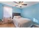 Cozy bedroom with a ceiling fan, window with sheer curtains, and tile flooring at 2035 29Th N Ave, St Petersburg, FL 33713