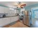 Well-lit kitchen with stainless steel appliances, white cabinets, tile flooring, and a stainless refrigerator at 2035 29Th N Ave, St Petersburg, FL 33713