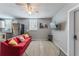 Inviting living space offers a red sofa, stainless steel kitchen appliances, and a decorative rug at 2035 29Th N Ave, St Petersburg, FL 33713