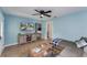 Inviting living room features blue walls, modern TV, and cozy seating, blending style and comfort at 2035 29Th N Ave, St Petersburg, FL 33713
