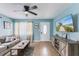 Cozy living room features neutral-toned sofa, TV, and blue accent wall, perfect for relaxing at 2035 29Th N Ave, St Petersburg, FL 33713