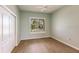 Simple bedroom featuring wood floor and a double door closet with blinds at 2100 Aqui Esta Dr, Punta Gorda, FL 33950