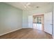 Bedroom with wood floor and double doors to an adjoining room with views of the pool at 2100 Aqui Esta Dr, Punta Gorda, FL 33950