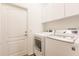 Bright laundry room features cabinets and new LG washer and dryer appliances at 2100 Aqui Esta Dr, Punta Gorda, FL 33950
