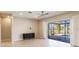 Neutral living room with tiled floors, black storage chest, and view of the outdoor pool at 2100 Aqui Esta Dr, Punta Gorda, FL 33950