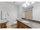 Bathroom featuring a granite countertop, wood cabinets, toilet, and a large mirror at 2129 Lennox Dale Ln, Brandon, FL 33510