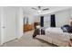 Inviting bedroom with a ceiling fan, neutral carpet, and wooden furniture at 2129 Lennox Dale Ln, Brandon, FL 33510