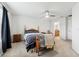 Large bedroom featuring a ceiling fan, neutral carpet, and wooden furniture at 2129 Lennox Dale Ln, Brandon, FL 33510