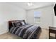 Bright bedroom featuring a queen bed with a striped comforter, ceiling fan, and a window at 2129 Lennox Dale Ln, Brandon, FL 33510