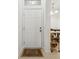 Bright entryway featuring a six-panel door and neutral colored tiled flooring at 2129 Lennox Dale Ln, Brandon, FL 33510