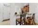 Eat-in kitchen featuring breakfast bar, granite countertops, and wooden cabinetry at 2129 Lennox Dale Ln, Brandon, FL 33510