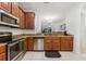 Charming kitchen featuring granite countertops, stainless steel appliances, and wooden cabinets at 2129 Lennox Dale Ln, Brandon, FL 33510