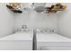 Laundry room featuring a washer and dryer with wire shelving at 2129 Lennox Dale Ln, Brandon, FL 33510