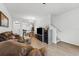 Open-concept living room featuring hardwood floors, modern lighting, and comfortable leather furniture at 2129 Lennox Dale Ln, Brandon, FL 33510