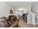Spacious living room features hardwood flooring, modern lighting, and comfortable leather furniture at 2129 Lennox Dale Ln, Brandon, FL 33510