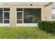 A view of the screened-in patio with sliding glass doors and a ceiling fan at 2129 Lennox Dale Ln, Brandon, FL 33510