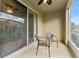 Outdoor patio with ceiling fan, chairs, and sliding glass door at 2129 Lennox Dale Ln, Brandon, FL 33510