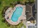 Overhead view of the community pool with tables, lounge chairs and an umbrella shaded area at 2129 Lennox Dale Ln, Brandon, FL 33510