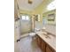 Bathroom featuring a tiled shower with safety bar, vanity with sink, and mirrored medicine cabinet at 2360 Irish Ln # 16, Clearwater, FL 33763