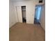 Bedroom with carpet, closet, and access to other rooms at 2360 Irish Ln # 16, Clearwater, FL 33763
