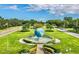 Community landmark featuring a beautiful fountain with a large globe, surrounded by manicured lawns and mature trees at 2360 Irish Ln # 16, Clearwater, FL 33763
