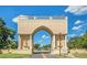Grand entrance to the community features an impressive archway, statues, and lush landscaping, creating a welcoming ambiance at 2360 Irish Ln # 16, Clearwater, FL 33763