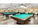 Spacious game room featuring multiple billiard tables under bright pendant lights, ideal for friendly competition and entertainment at 2360 Irish Ln # 16, Clearwater, FL 33763