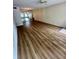 Spacious living room with wood-look flooring and a mirrored wall at 2360 Irish Ln # 16, Clearwater, FL 33763