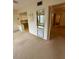 Open-concept living room with neutral carpet, large mirror, and entryways to other rooms at 2360 Irish Ln # 16, Clearwater, FL 33763