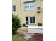 Outdoor patio area with sliding glass door entry, utility storage, and privacy landscaping at 2360 Irish Ln # 16, Clearwater, FL 33763