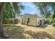 A spacious backyard featuring a storage shed and lush greenery at 2604 E Chelsea St, Tampa, FL 33610