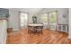 Cozy dining area with hardwood floors, a white table, and bright natural light streaming through the windows at 2604 E Chelsea St, Tampa, FL 33610