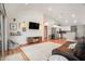 Spacious living room with hardwood floors, an open floor plan, and a view into the modern kitchen at 2604 E Chelsea St, Tampa, FL 33610