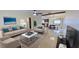 Bright, open-concept living room with stylish furniture, ceiling fan, and seamless flow to dining area at 306 Oak Ave, Brandon, FL 33510