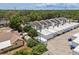 Aerial view showcases the townhome complex, highlighting the rooflines, parking, and surrounding greenery at 3413 W Kirby St, Tampa, FL 33614
