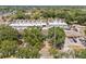 Aerial perspective of the townhome community, showing the layout, trees, and nearby street at 3413 W Kirby St, Tampa, FL 33614