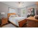Cozy bedroom featuring a neutral color palette, comfortable bed, and window with natural light at 3413 W Kirby St, Tampa, FL 33614