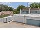 Exterior view showcasing a townhome with white garage doors and a flat roof with mounted HVAC system at 3413 W Kirby St, Tampa, FL 33614
